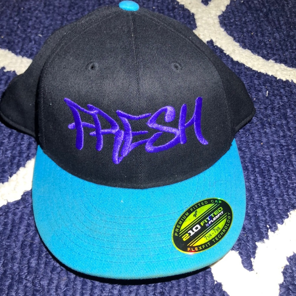 A fitted hat that black purple and teal